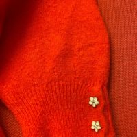 orange-red flower button knit close up