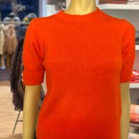 orange-red flower button knit on manequinn